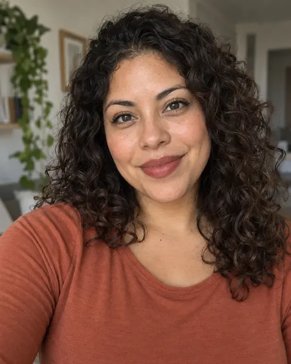 The original photo: a woman with curly dark hair, before the style